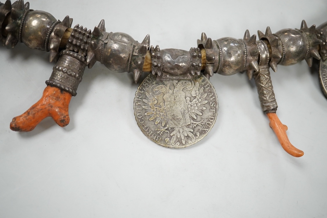 A Bedouin white metal and coral mounted necklace, from Oman, 58cm long